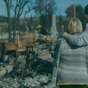 Couple observes their home destroyed by Hurricane Helene, representing the devastation of the natural disaster and the IRS tax relief available for affected Florida taxpayers