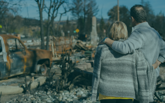 Couple observes their home destroyed by Hurricane Helene, representing the devastation of the natural disaster and the IRS tax relief available for affected Florida taxpayers