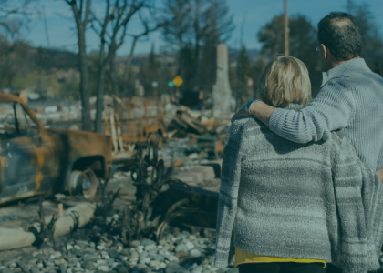 Couple observes their home destroyed by Hurricane Helene, representing the devastation of the natural disaster and the IRS tax relief available for affected Florida taxpayers